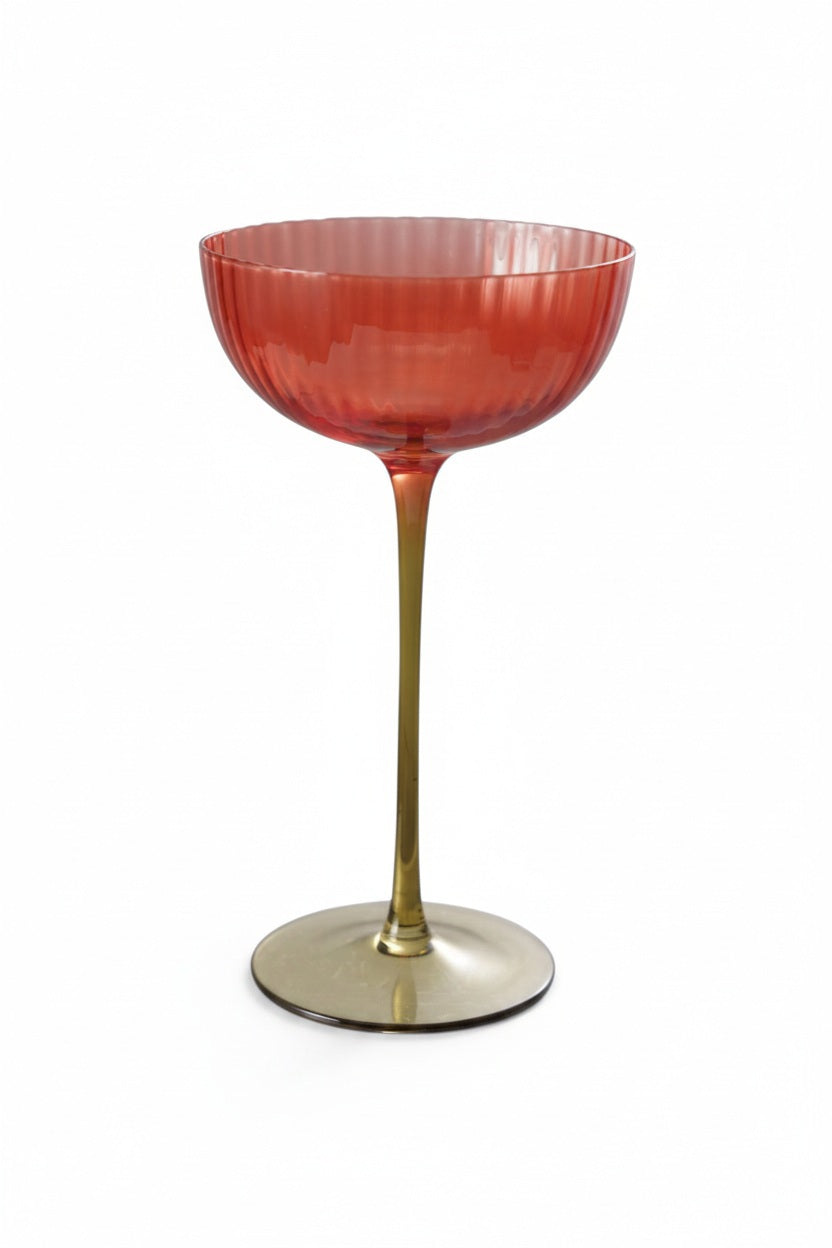 RIBBED STEMMED COUPE GLASS in red with a long, thin, gradient stem, serving as an elegant artisan wine glass.