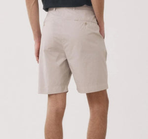 A person models the HARTFORD - TAYLOR SHORTS IN STONE by HARTFORD, shown in light beige against a plain white background. The image is cropped to display only the lower torso and legs.