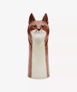 The QUAIL CERAMICS - FOX FLOWER VASE by QUAIL DESIGNS is a handpainted stoneware vase shaped like a fox’s head and neck, with brown fur, white accents, and a black nose, shown in profile against a white background.
