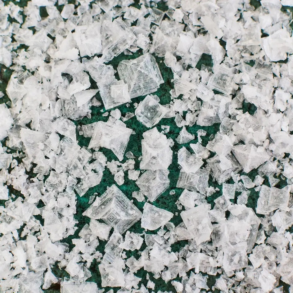 A box of MALDON - SEA SALT FLAKES by GOURMET FOOD SOLUTIONS, featuring a green geometric pattern and the text “Maldon Sea Salt Flakes” on the front.