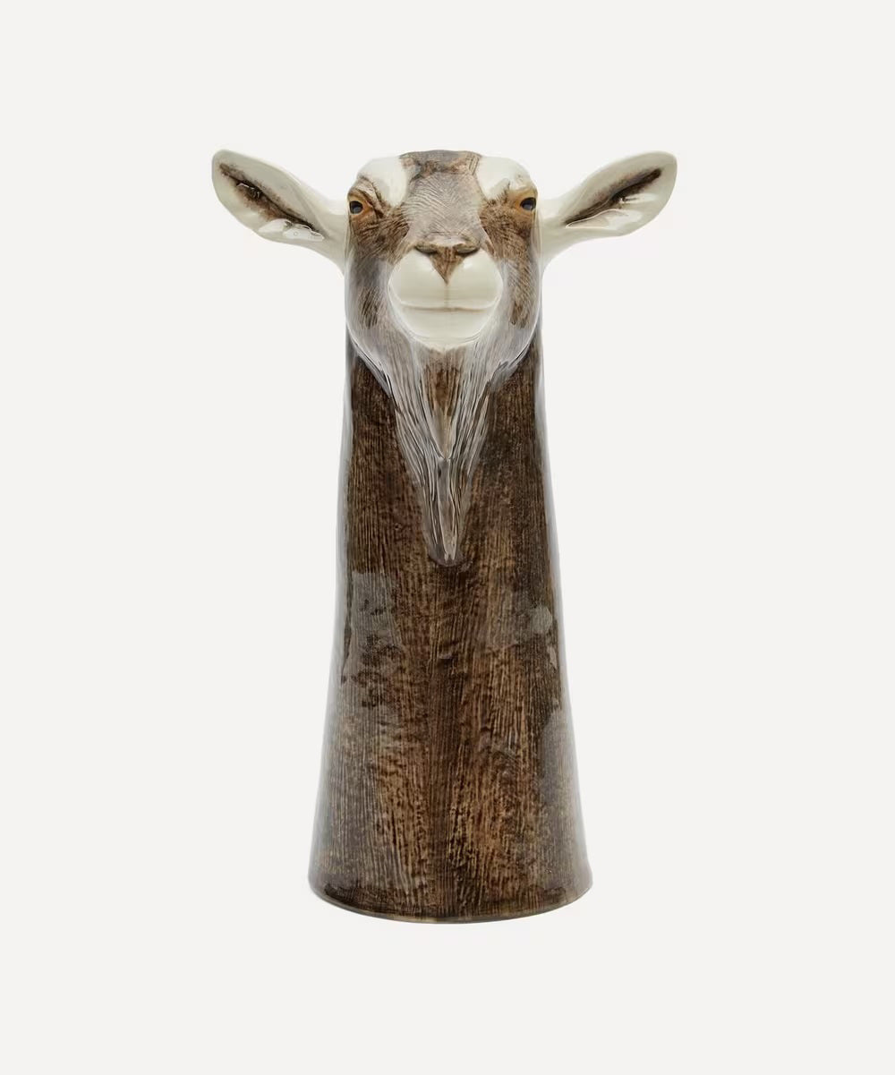 The QUAIL DESIGNS QUAIL CERAMICS - GOAT FLOWER VASE is a hand-painted ceramic vase shaped like a goat's head with brown and white details, upright ears, and realistic features, shown on a plain white background.