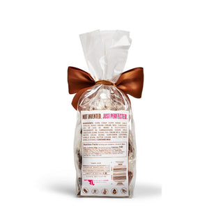 A clear bag of MOUTH PARTY - OMG BAG caramels, including sea salt caramel, is tied with a copper satin bow. The label says "Mouth Party Caramel OMG! NET WT. 6oz (170g)." Brand: MOUTH PARTY.