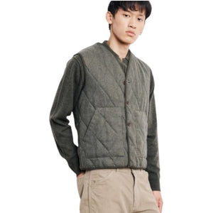 A person with short black hair, wearing a silver hoop earring and the HARTFORD - VINCE Wool Flannel Vest in Army, is shown from the back against a plain white background.