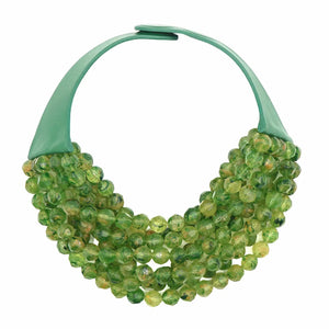 The FAIRCHILD BALDWIN - THE BELLA NECKLACE showcases layered strands of iridescent green Italian resin beads with a faceted design for a shimmering effect, finished with a smooth light green clasp that complements its vibrant hues.