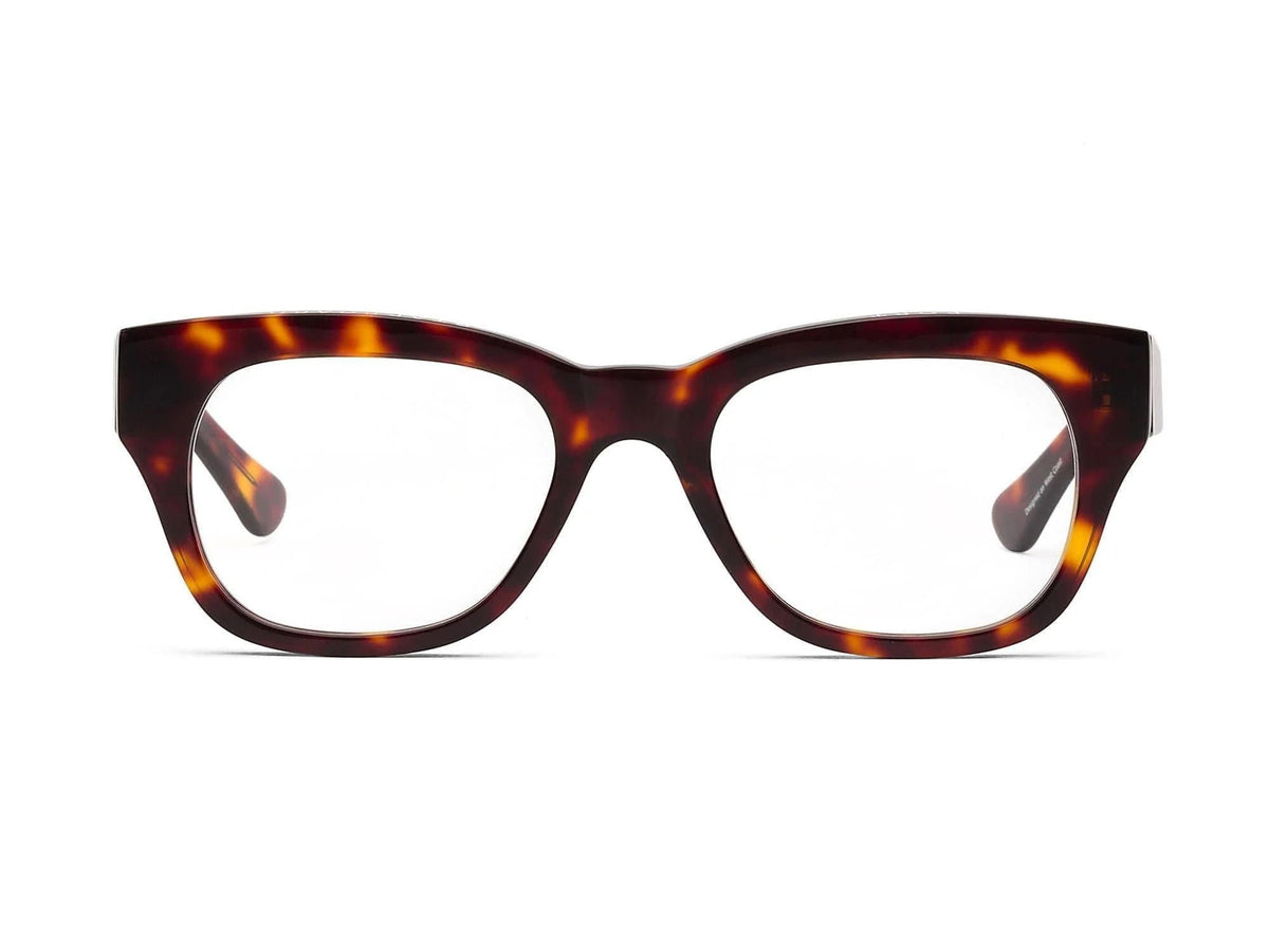 The CADDIS - MIKLOS PROGRESSIVE READERS by CADDIS are eyeglasses featuring thick, rectangular tortoiseshell premium acetate frames with clear lenses, displayed against a white background.