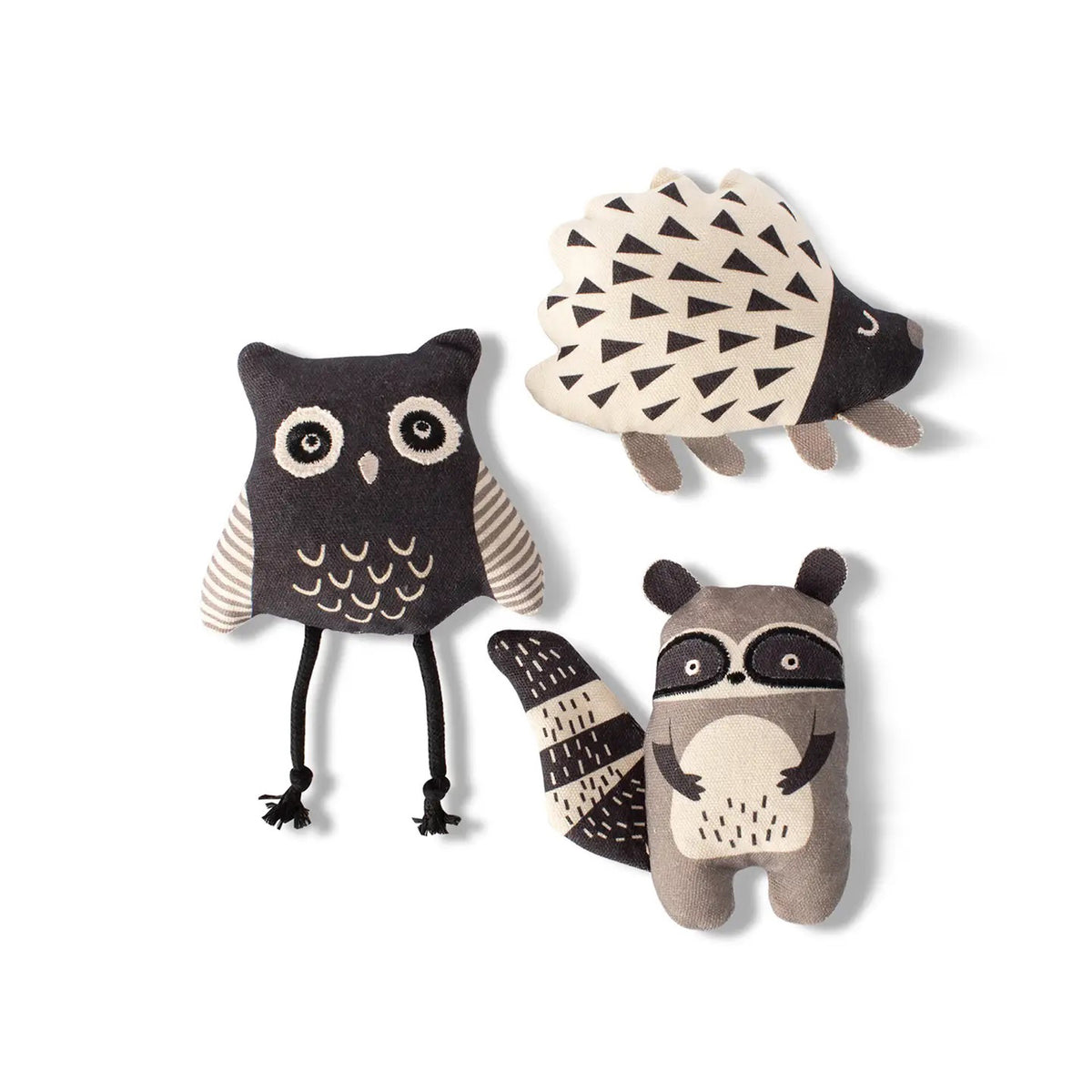 The FRINGE STUDIO Mini Wild Ones Pet Toy by PET SHOP features a black and white owl with dangling legs, a hedgehog with triangular patterns, and a raccoon with distinct facial markings, all crafted from soft cotton canvas using non-toxic inks. They&#39;re ideal for small to medium dogs.