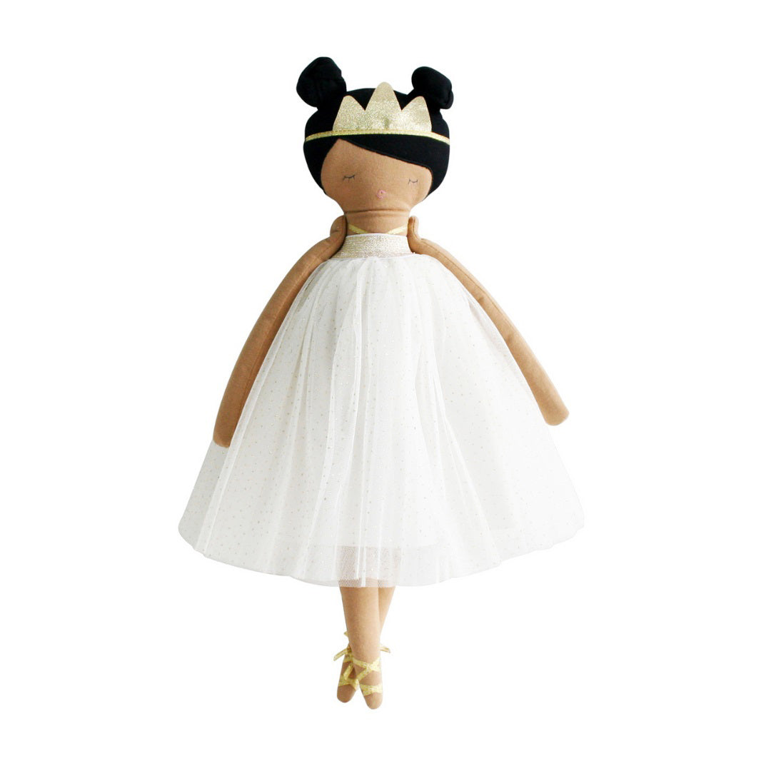 The ALIMROSE - PANDORA PRINCESS DOLL by ALIMROSE features dark hair styled in two buns, adorned with a gold crown, and is dressed in a white tulle overlay dress. The doll has brown stitched arms and legs, gold ballet slippers, and a minimalist embroidered face.