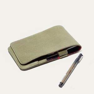 The WILL LEATHER GOODS - GOLF YARDAGE BOOK IN GREEN, made from khaki green full-grain leather, features a pen loop and is shown closed on a plain white background.
