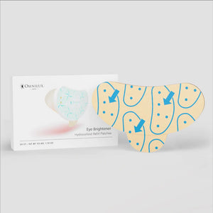 A person with gray hair uses the OMNILUX EYE BRIGHTENER HYDROCOLLOID REFILL PACK, a pink skincare tool, applying it near their cheek. The neutral background enhances this self-care routine with under-eye gel patches infused with niacinamide.