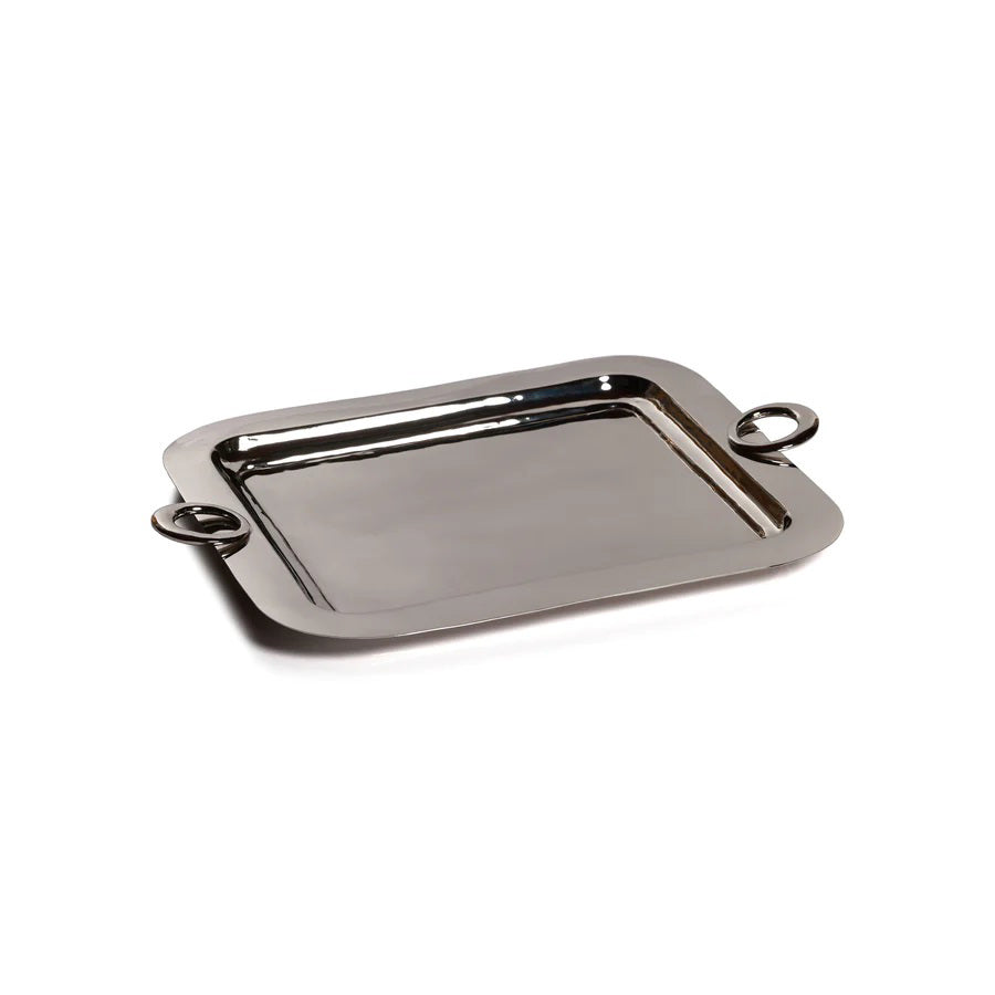 The ZODAX POLISHED BRASS SERVING TRAY is a rectangular metal tray with rounded corners and two circular handles, shown on a white background. Size: 21.25 in x 15.5 in x 1 in.