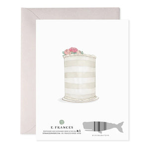 The E. FRANCES PAPER Wedding Rings Greeting Card showcases two intertwined gold rings tied with a gray ribbon and elegant foil accents, inscribed with "FOREVER AND EVER." A handcrafted watercolor touch enhances the card, complemented by a beige envelope.