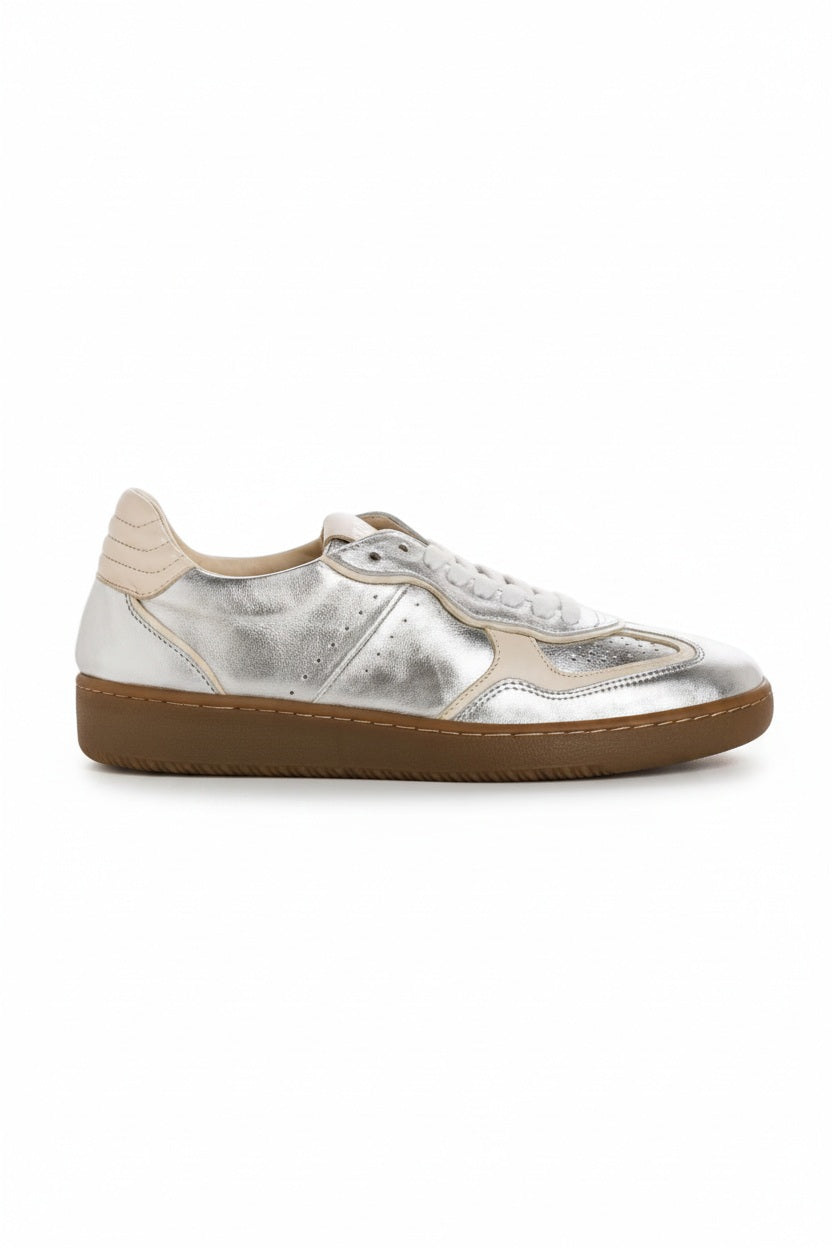 A top view of the REQINS - ATHENA METALLIC SNEAKER IN SILVER, featuring stylish silver suede, white laces, silver accents, and a beige sole by REQINS, displayed on a plain light background.