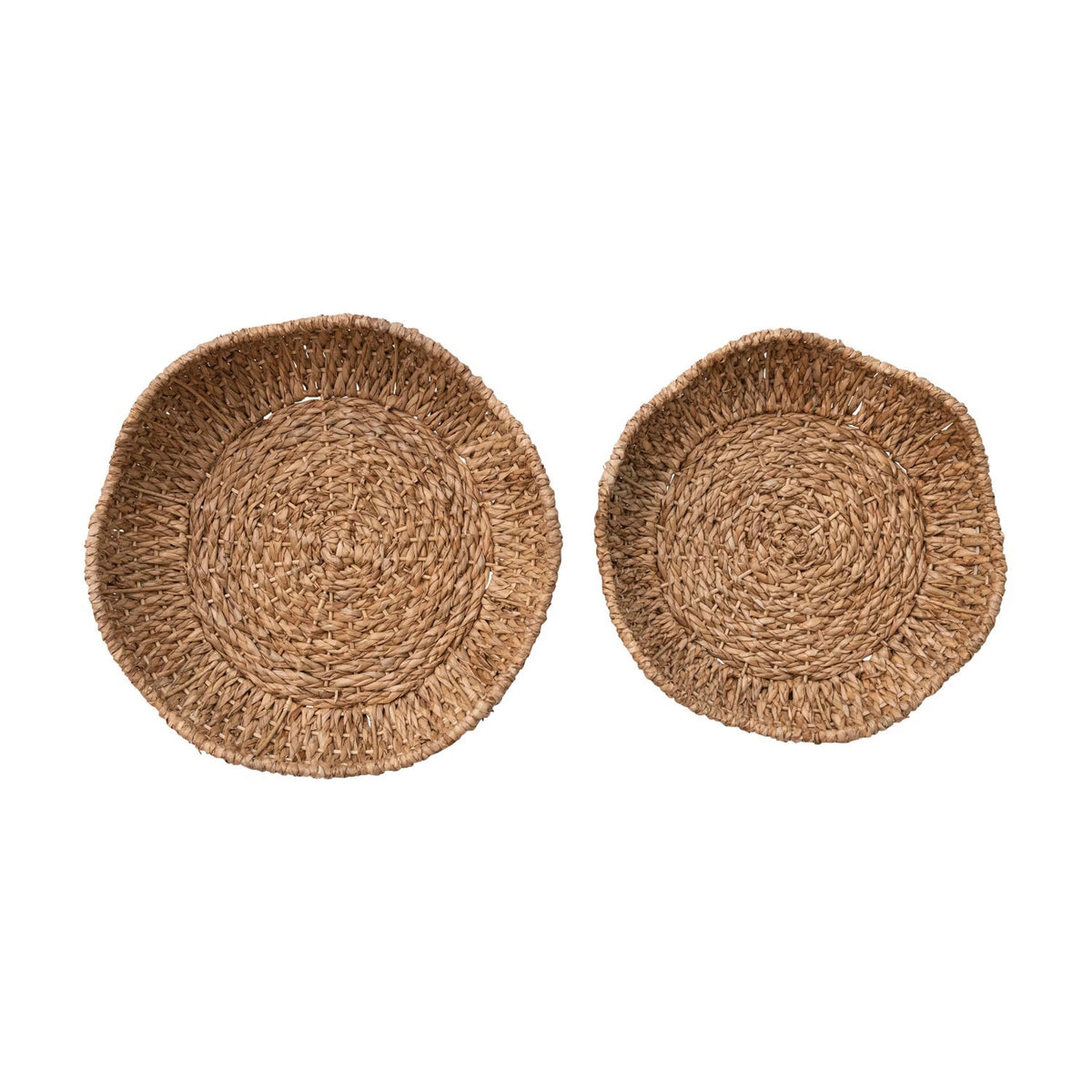 Displayed against a plain white background are two circular woven wicker baskets of different sizes. Reminiscent of the BRAIDED BANKUAN BOWL WITH SCALLOPED EDGE (LARGE) by CREATIVE COOP, these baskets feature a natural, rustic appearance with a textured finish and slightly irregular edges.