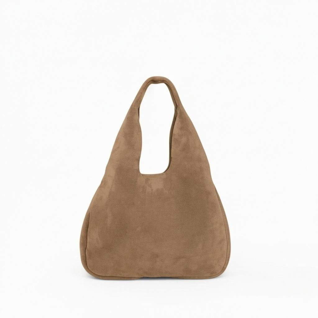 The OLIVEVE Francesca Shopper in Amphora Italian leather backed suede is a tan handbag with a wide, rounded body, a large single shoulder strap, and solid brass hardware, displayed against a plain white background.