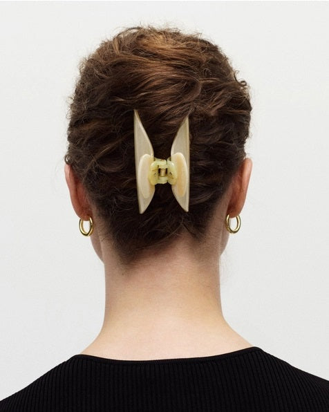 The MACHETE - MIDI HEIRLOOM CLAW by MACHETE is featured against a plain white background. This cream-colored hair accessory is crafted from luxurious Italian acetate and features curved edges with interlocking teeth, making it ideal for securing medium hair with effortless style.