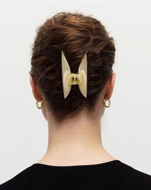The MACHETE - MIDI HEIRLOOM CLAW by MACHETE is featured against a plain white background. This cream-colored hair accessory is crafted from luxurious Italian acetate and features curved edges with interlocking teeth, making it ideal for securing medium hair with effortless style.