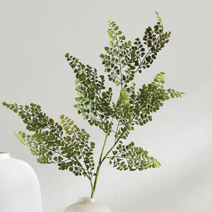 The NAPA HOME AND GARDEN - Maidenhair Faux Fern Stem features a single green fern with delicate, lacy leaves on a central stem against a white backdrop, perfect for adding elegance and nature to any space. Ideal for product descriptions visualizing size and elegance effortlessly.