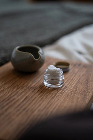 A set of MADISON GREEN - REST YOUR EYES ON THE BED relaxing eye masks and a small jar, all packaged in minimalist white with light brown text, displayed against a plain white background.