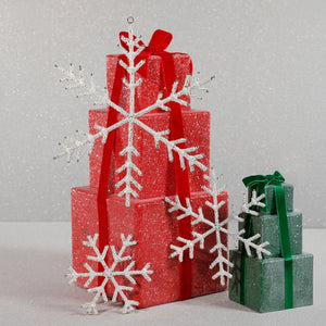 Two 6-inch stacks of glittery red and green gift boxes decorated with three large ZODAX BEADED SNOWFLAKE ORNAMENT 6″ pieces made from iron and glass beads.