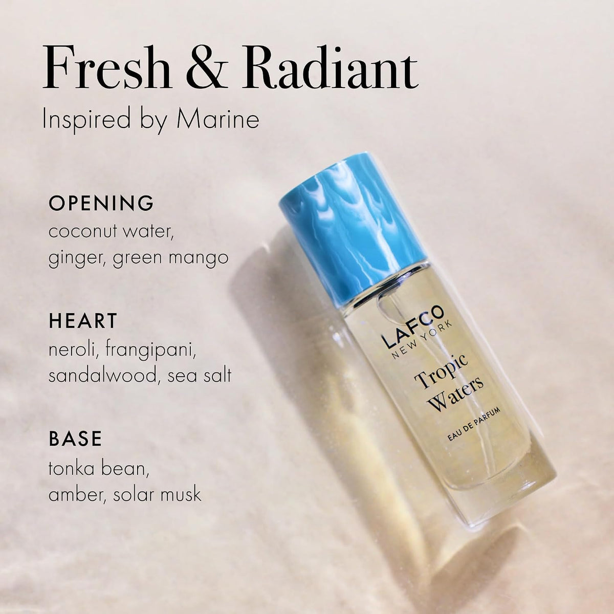 A LAFCO FINE FRAGRANCE, TROPIC WATERS 10ML box stands upright in a halved coconut, water splashing around it against a neutral background—an evocative display for this long-lasting scent inspired by the essence of coconut water.