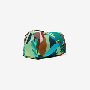 The INOUI EDITIONS VOYAGE NYLON CASE, SMALL features a vibrant tropical print with abstract birds in green, brown, blue, and orange on a light background. This artistic INOUI pouch is perfect as a travel organizer for your essentials.