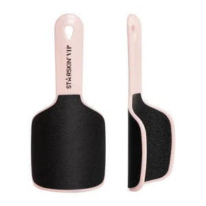 A dual-view image of the FAB FOOT FILE by STARSKIN, featuring a beige handle and black abrasive surface, ideal for callus removal. One view shows the file from the front, while the other presents a side profile. The branding text on the handle reads "ST-XRSIN VIP." This reusable foot file ensures lasting smoothness.