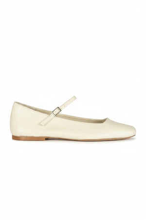 The AUGUSTA - JULIETA MARY JANE by AUGUSTA is a black leather Mary Jane flat with a thin strap and buckle, light brown sole, and subtle square toe, handcrafted in Spain and shown on a light gray background.