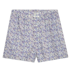 A person stands against a plain background, wearing HARTFORD – COTTON BOXER SHORTS, PATTERN by HARTFORD, featuring a light-colored animal print and crafted from upcycled cotton boxer briefs. Only the lower torso and upper legs are visible.