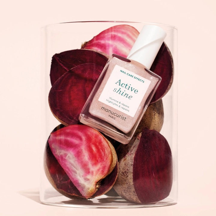 MANUCURIST - ACTIVE™ SHINE TREATMENT POLISH by MANUCURIST INC is a shimmery pink nail treatment polish formulated with beetroot extract for hydrating and providing antioxidant care to nails, AHAs to restore and harden, and hexanal to help strengthen them. The product contains 79.5% plant-based ingredients.