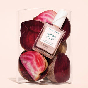 MANUCURIST - ACTIVE™ SHINE TREATMENT POLISH by MANUCURIST INC is a shimmery pink nail treatment polish formulated with beetroot extract for hydrating and providing antioxidant care to nails, AHAs to restore and harden, and hexanal to help strengthen them. The product contains 79.5% plant-based ingredients.