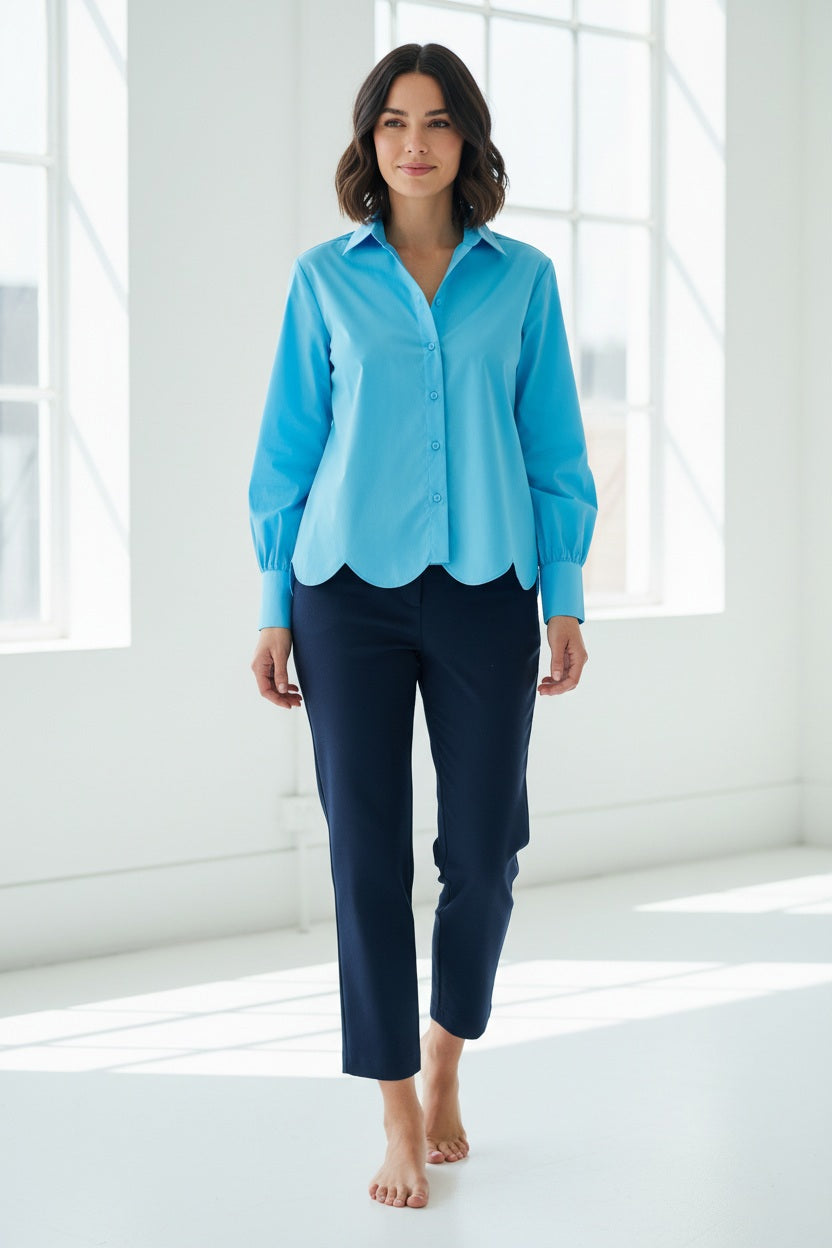 A person with short hair wears a bright green HINSON WU Blaire Scallop Hem Shirt and light blue stretch cotton jeans. One hand is in their pocket, and they sport a bracelet against a plain white background.