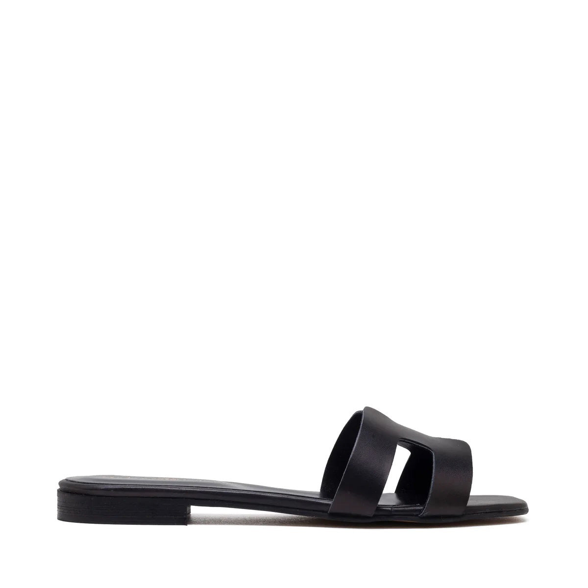 The image depicts the MICHELE LOPRIORE - H SLIDE, a single brown leather slide sandal with an open-toe design. The upper features two wide straps with geometric cutouts. The thin sole appears to be made of light brown wood-like material. Made in Italy by MICHELE LOPRIORE, the sandal is displayed against a plain white background.