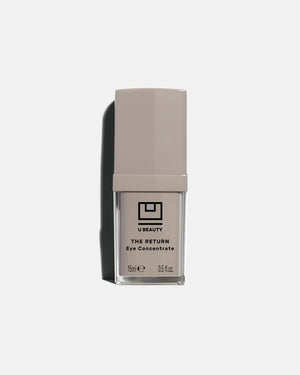 A beige and clear rectangular bottle of U BEAUTY THE RETURN EYE CONCENTRATE 15ML is displayed upright on a light gray background with a left-side shadow. This eye cream targets dark circles and revives tired eyes.