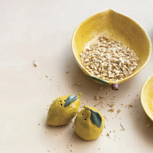 The CREATIVE COOP STONEWARE LEMON-SHAPED SALT AND PEPPER SHAKERS, featuring hand-painted yellow lemons with green leaves, add a cheerful accent to your kitchen décor whether upright or lying down.