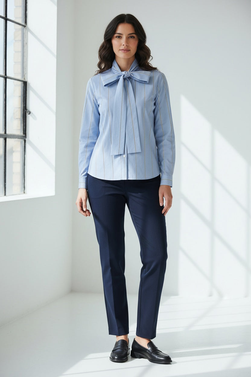 The SEVENTY VENEZIA - BLUE STRIPE SHIRT by SEVENTY features thin white vertical stripes, a chic bow tie collar, and an elegant high neck.
