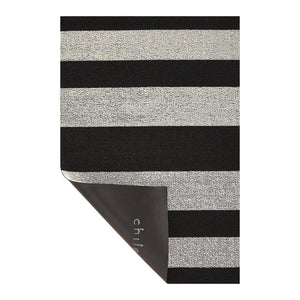 The CHILEWICH Black and White Bold Stripe Shag Doormat, measuring 18x28, features a rectangular design with alternating horizontal black and white stripes, offering an easy-care solution perfect for both indoor and outdoor use.
