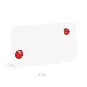 E. FRANCES PAPER's E. FRANCES - LITTLE NOTES LADYBUG features a rectangular stack of mini note cards with red flower accents on the front, green leaf pattern on the back, and comes packaged reading "Little Notes." Yellow pencil shown for scale.