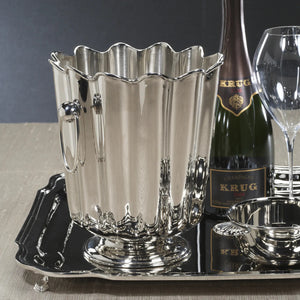 The ZODAX ORLEANS Wine or Champagne Bucket is a shiny silver piece with vertical ridges, scalloped edges, two round side handles, and stands 9 inches tall—an elegant decorative item shown on a white background.