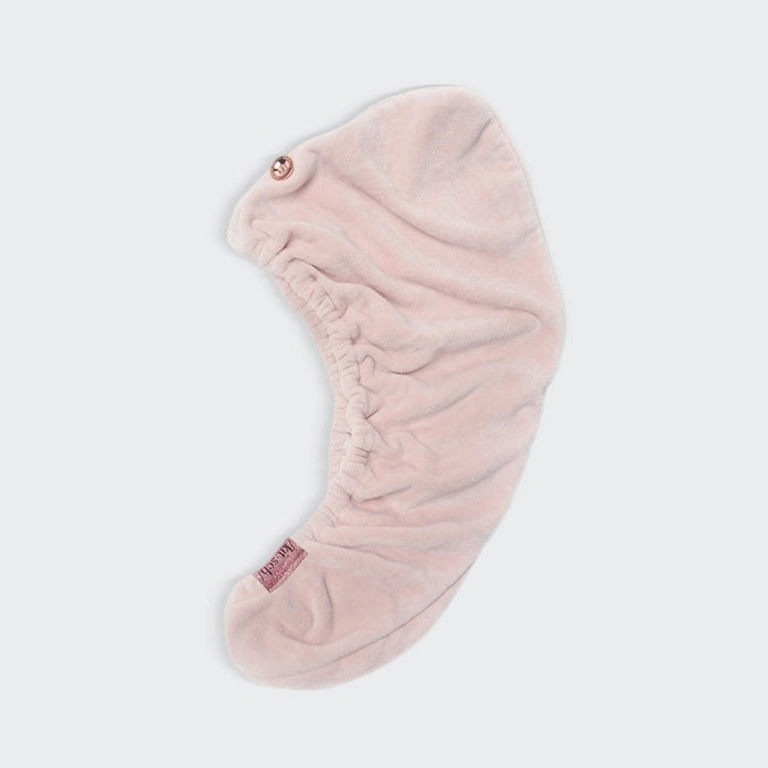 The KITSCH Quick Dry Hair Towel packaging highlights its luxurious eco-friendly blend of organic cotton and bamboo, showcasing softness and high absorbency. An image emphasizes friction-free drying, with the towel elegantly displayed beside the box, reflecting its natural allure.