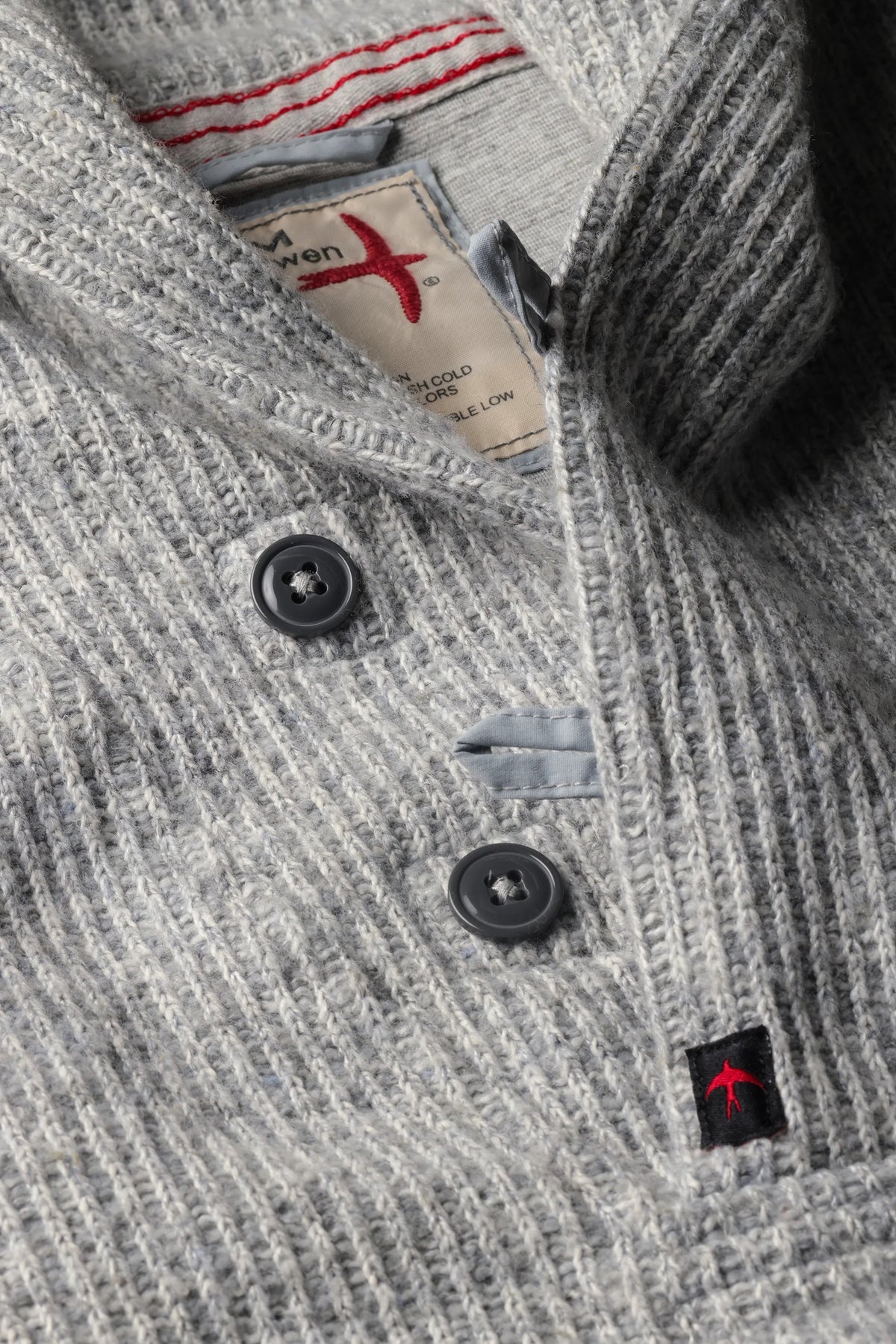The RELWEN Ridge Twist Shawl Sweater in Pale Grey Heather is a vintage-style piece with ribbed cuffs and hem, a hood, and a small tag near the neckline, shown laid flat on a white background.