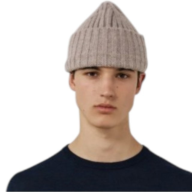 A nut-colored ribbed beanie by HARTFORD, expertly crafted from a soft cashmere and wool blend, featuring a folded cuff and shown against a plain white background, exuding luxurious knitwear appeal.