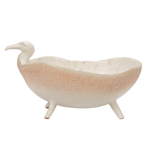 A close-up of the CREATIVE COOP WHITE SPECKLED BIRD-SHAPED STONEWARE FOOTED BOWL, featuring a gull-inspired design with a long beak and a smooth beige and light brown reactive glaze.