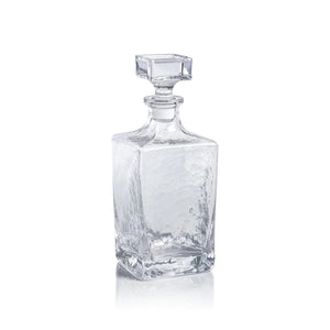The ZODAX PUNTA MITA Hammered Glass Decanter is a clear, rectangular 32 oz vessel with a square faceted stopper and textured glossy finish, shown against a plain white background.