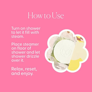 A green box labeled “MUSEE - BAMBOO & LOTUS SHOWER STEAMERS” is displayed, featuring four white round steamers embossed with a leaf design in front. The brand name “MUSEE” appears above the product name, highlighting these natural shower steamers crafted to deliver a spa-like experience.