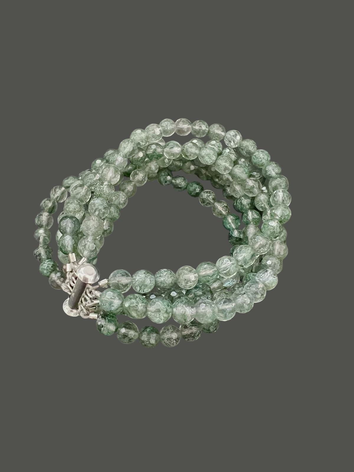 The ANN LIGHTFOOT &quot;Five Strand Green Quartz Bracelet&quot; features coiled, round translucent green beads with a crackled texture, fastened by a stainless steel clasp against a plain white background.