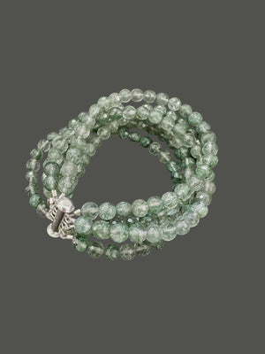 The ANN LIGHTFOOT "Five Strand Green Quartz Bracelet" features coiled, round translucent green beads with a crackled texture, fastened by a stainless steel clasp against a plain white background.