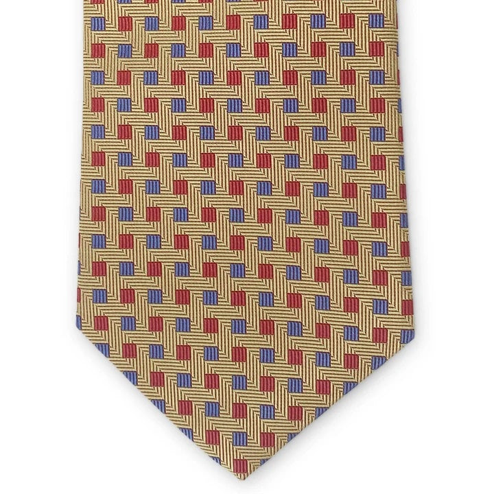 The BIRD DOG BAY PETER-BLAIR - BESPOKE SMALL SQUARES SILK TIE IN YELLOW is a rolled-up gold woven silk tie, showcasing a geometric pattern of red squares and small blue dots, with diagonal lines adding a textured appearance.