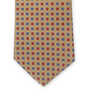 The BIRD DOG BAY PETER-BLAIR - BESPOKE SMALL SQUARES SILK TIE IN YELLOW is a rolled-up gold woven silk tie, showcasing a geometric pattern of red squares and small blue dots, with diagonal lines adding a textured appearance.