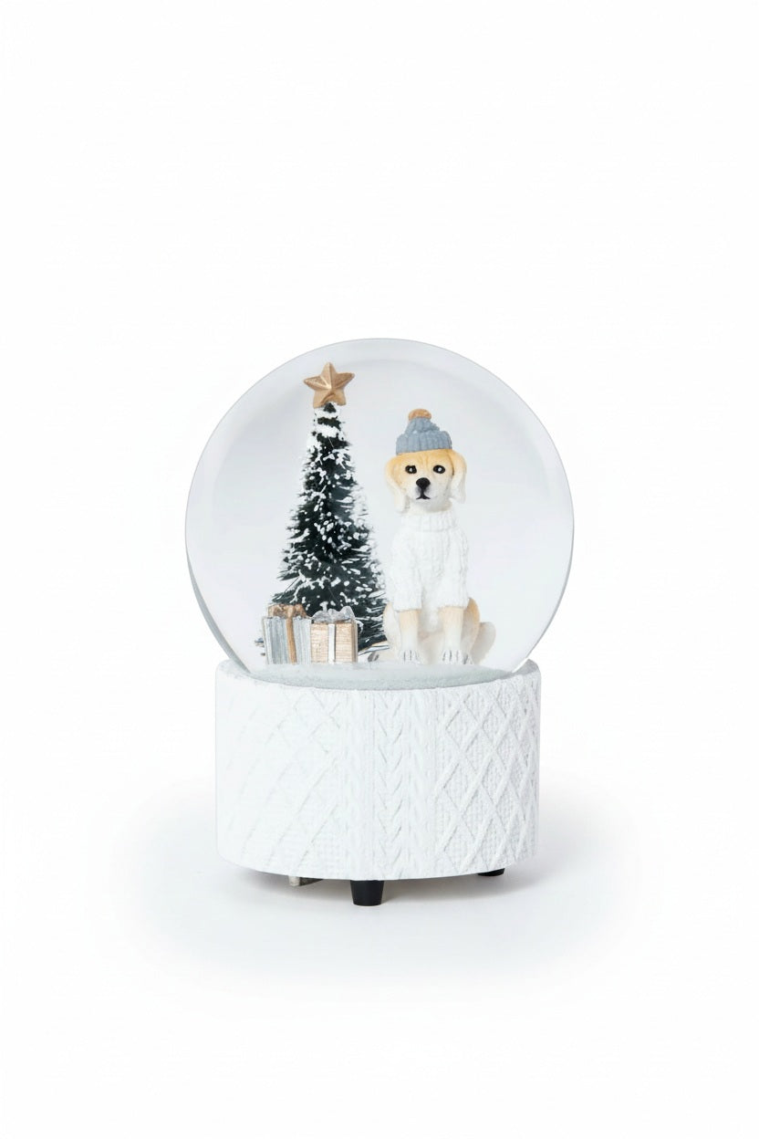 A ZODAX MOUNTAIN DOG WITH SWEATER SNOW GLOBE featuring a dog in a hat and sweater, a small Christmas tree, and gifts inside a resin glass ornament resting on a textured white base.