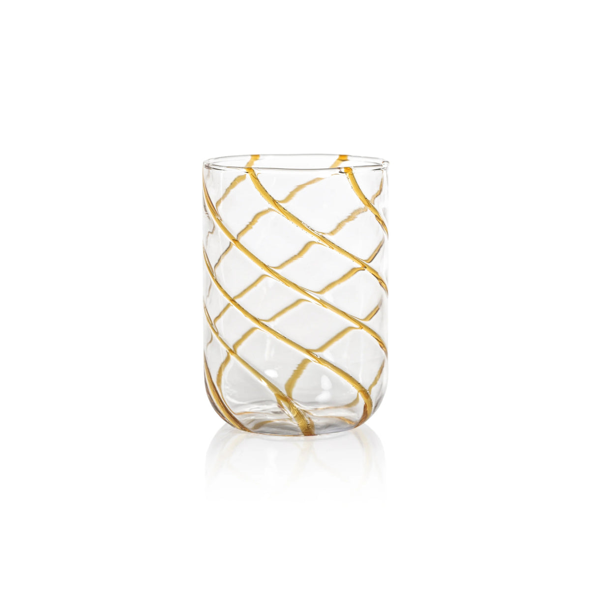 The AMBER SWIRL GLASS TUMBLER by ZODAX, a clear cylindrical glass adorned with bold gold diagonal swirl stripes, is elegantly displayed on a white background.